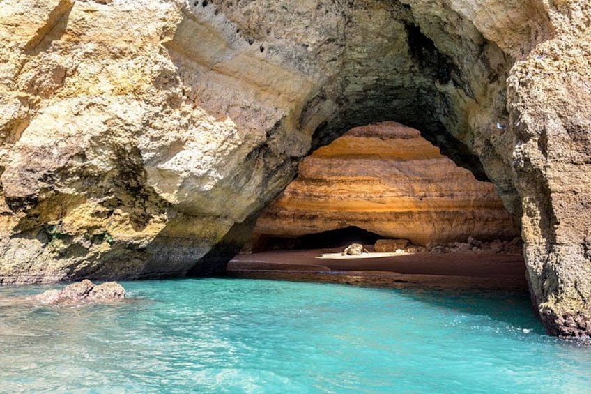 A natural rock arch over turquoise water. 4