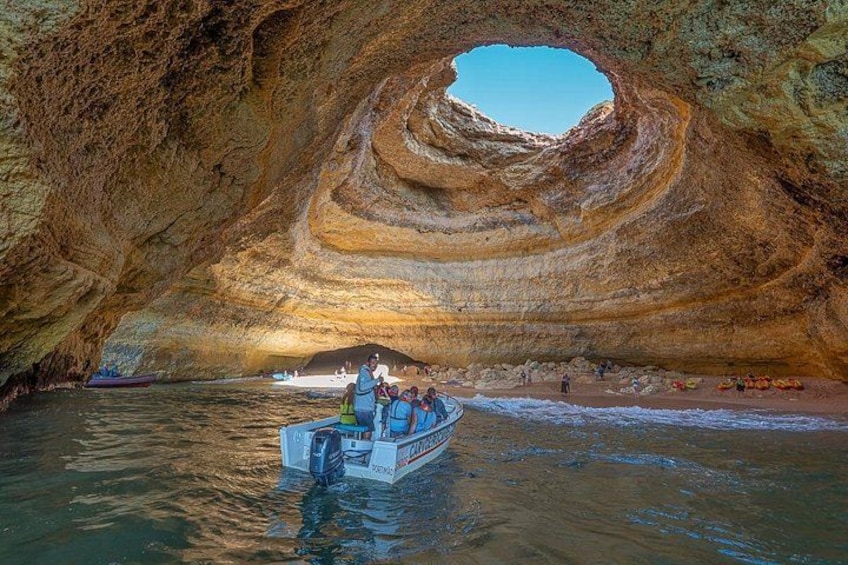 A boat in a cave with a circular opening. 1