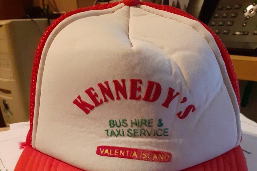 A cap with text reading 'KENNEDY'S BUS HIRE & TAXI SERVICE' and 'VALENTIA ISLAND.' 3