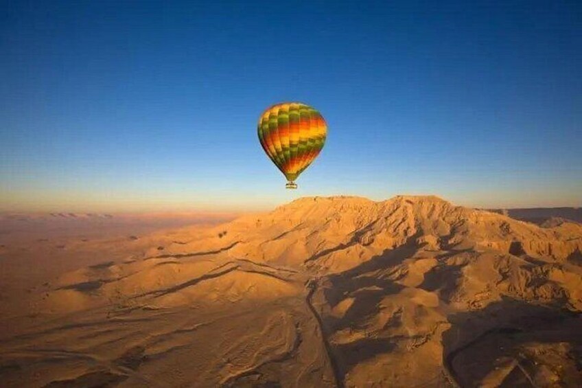 A hot air balloon over a desert landscape. 5