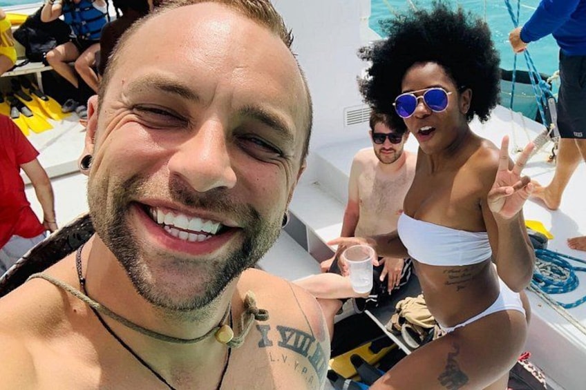 A person in a white bikini and another in a black and yellow swimsuit on a boat. 5