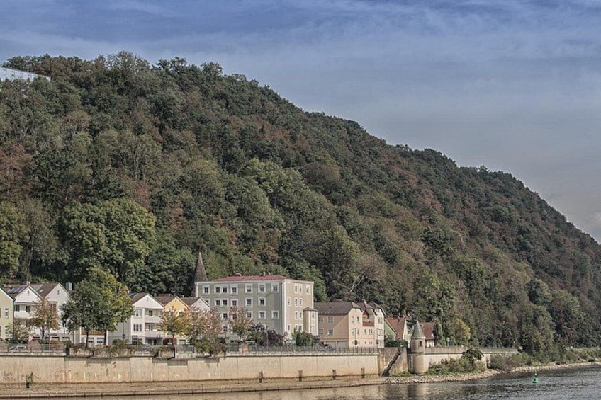A river, a bridge, and a hill with buildings. 4
