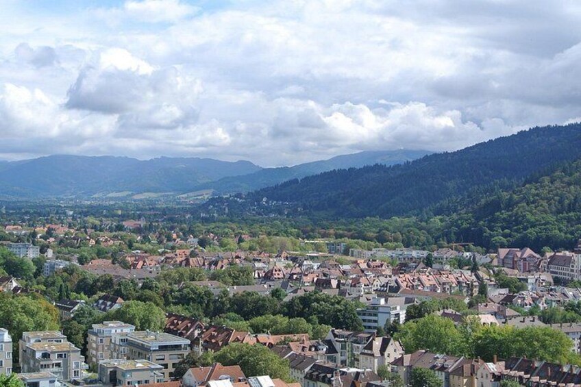 A town nestled in a valley with mountains in the background. 2