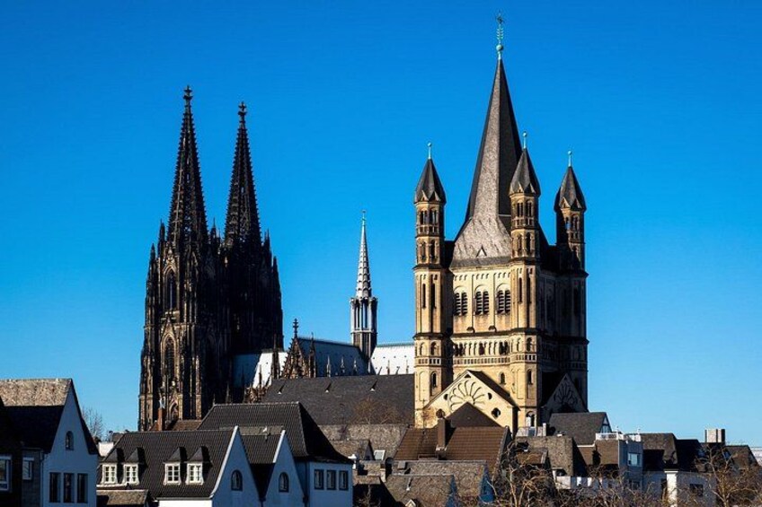A historic cathedral with twin spires and a smaller adjacent church. 2