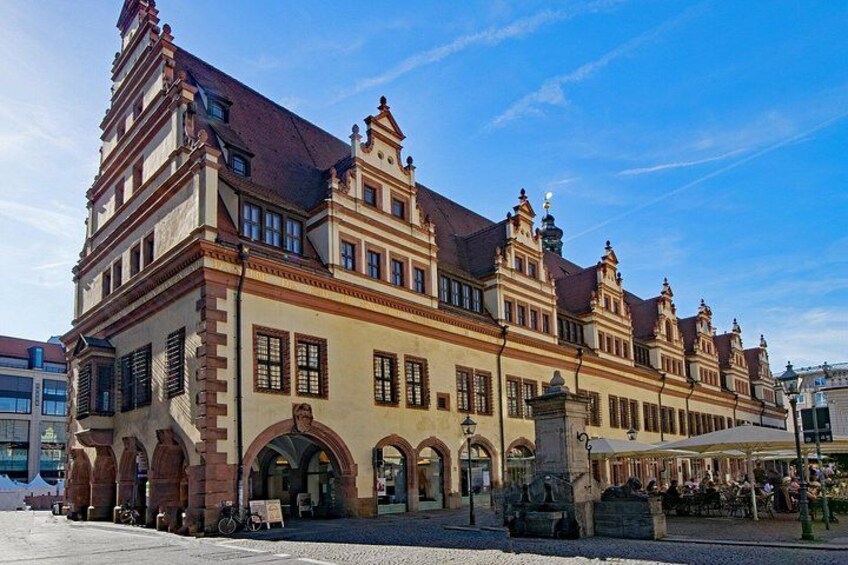 A historic building with a steeply pitched roof, arched windows, and ornate detailing. 2