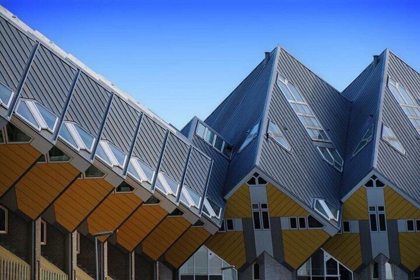 A modern architectural structure with geometric shapes and a clear blue sky. 2