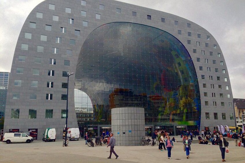 A modern building with a curved glass facade and a central cylindrical structure. 3