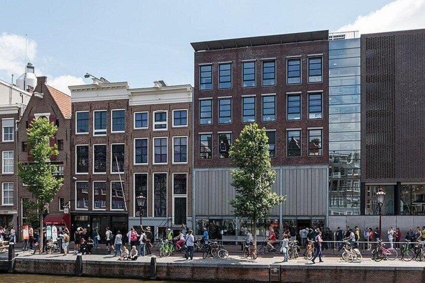 A busy urban street with pedestrians, bicycles, and modern buildings. 4