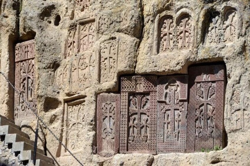 Ancient carved stone architecture with intricate patterns and designs. 2