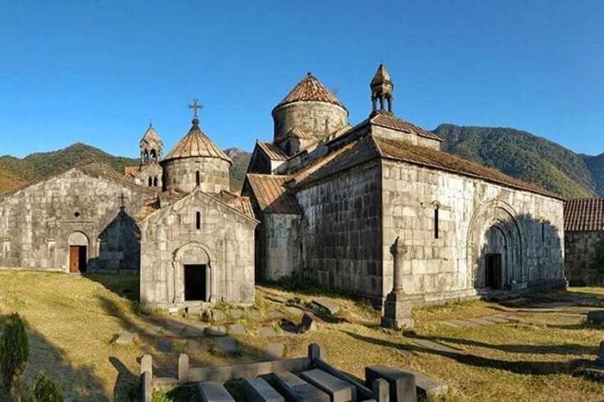 A historic church complex with multiple buildings, including a central structure with a dome and smaller attached buildings. 2