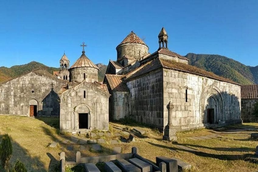 A historic church complex with multiple buildings, including a central structure with a dome and smaller attached buildings. 4