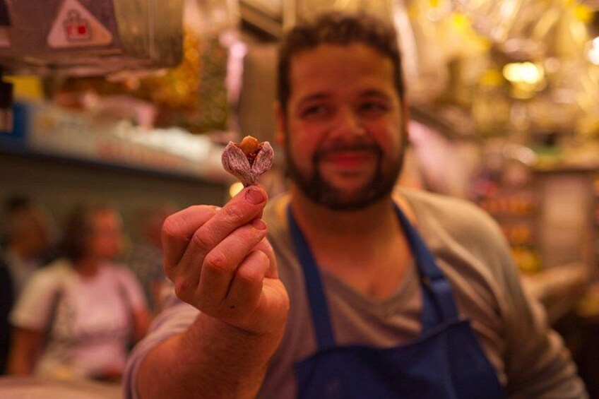 A person holding a small object. 3
