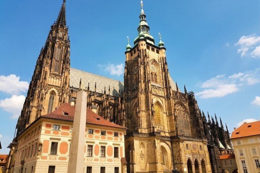 A historic cathedral with intricate Gothic architecture, a prominent spire, and adjacent traditional buildings. 5