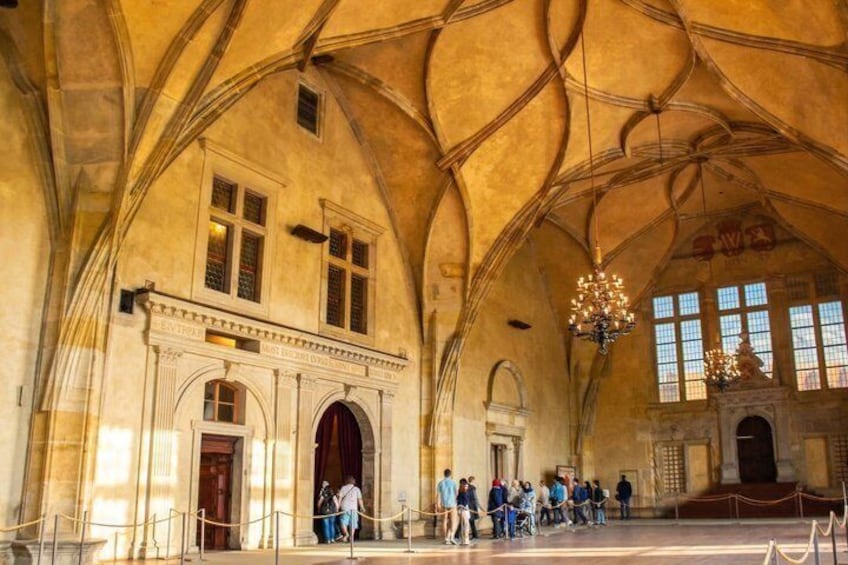 A historic building with arched ceilings, a grand entrance, and a chandelier. 5