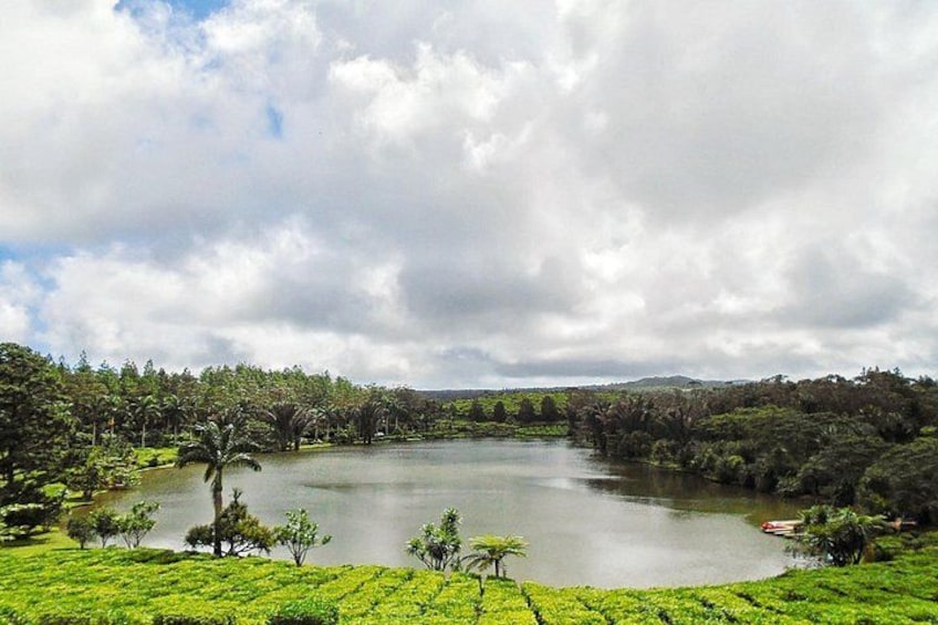 A lake surrounded by lush greenery and trees. 1
