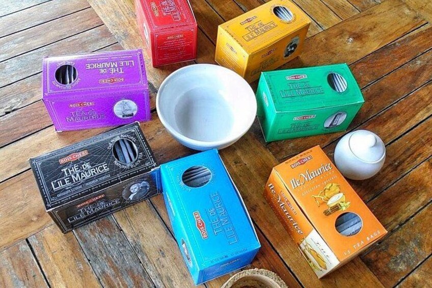 A wooden table with various colored boxes and a white bowl. 3