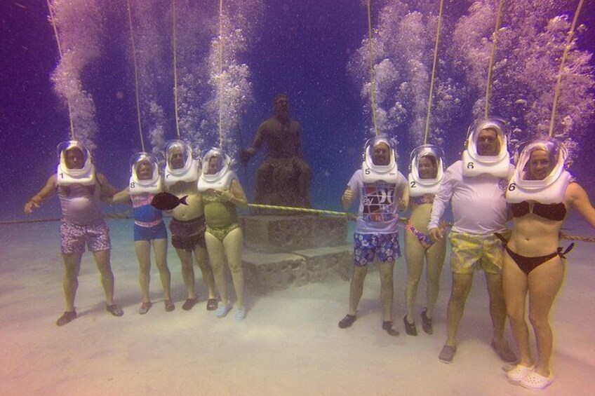 A group of people in astronaut suits standing underwater. 4