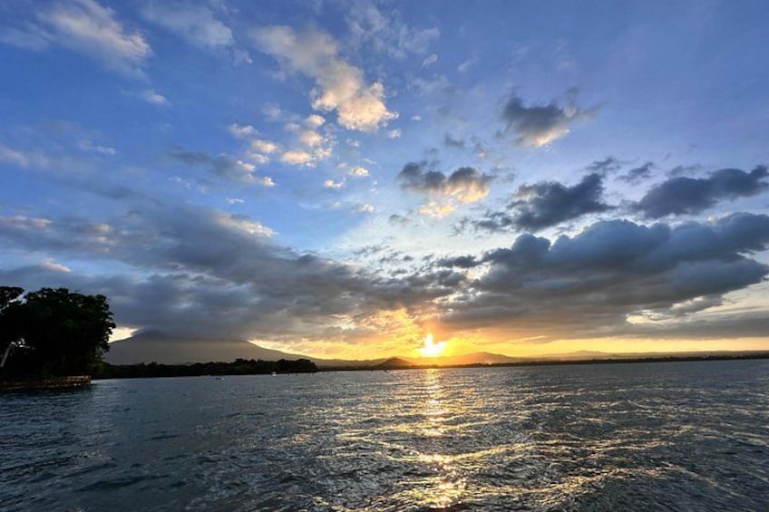 A sunset over a body of water with clouds reflecting sunlight. 4
