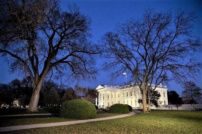 A large white building with columns, surrounded by trees and a well-maintained lawn. 5