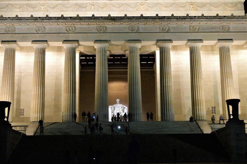 A grand building with large columns and a statue in the center. 1