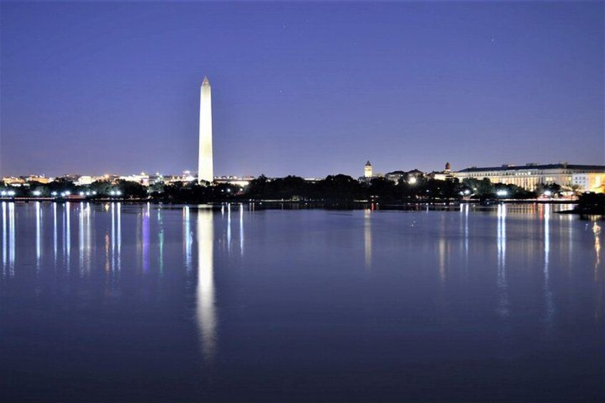 The Washington Monument reflected in a body of water at night. 4