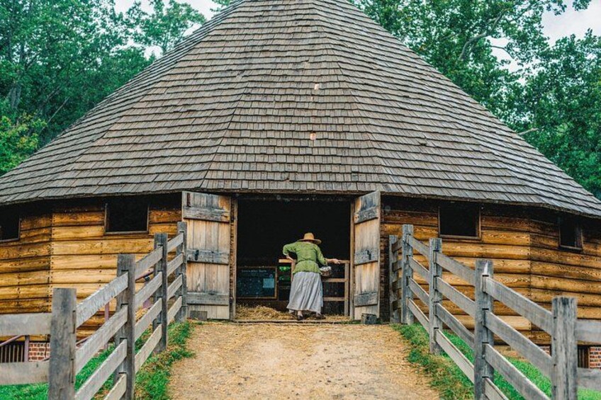 Dressed in period clothing, a guide opens Washington's 16-sided treading barn to visitors. 2