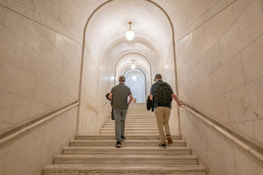 A marble staircase with two people ascending. 2