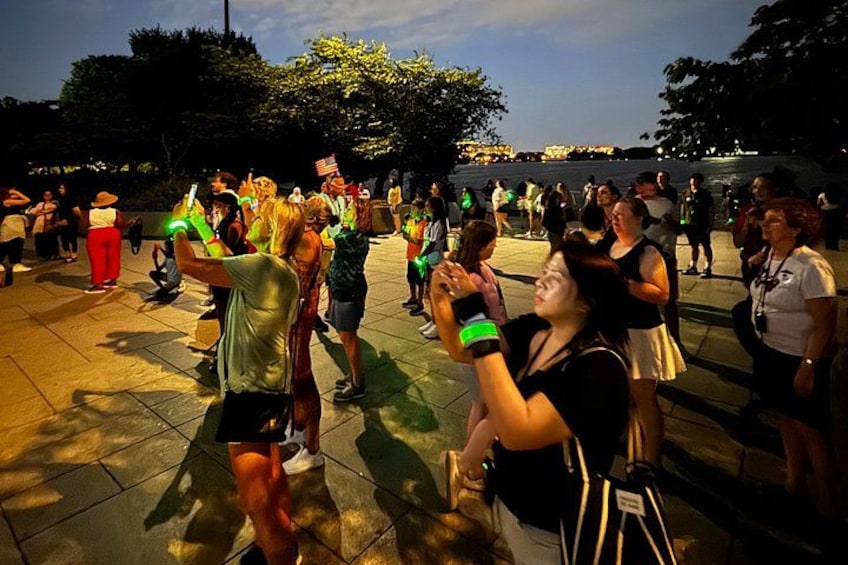 A group of people dancing outdoors in a public square. 5