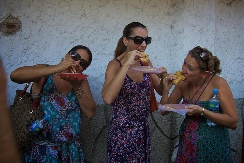 Three people eating at an outdoor setting. 2