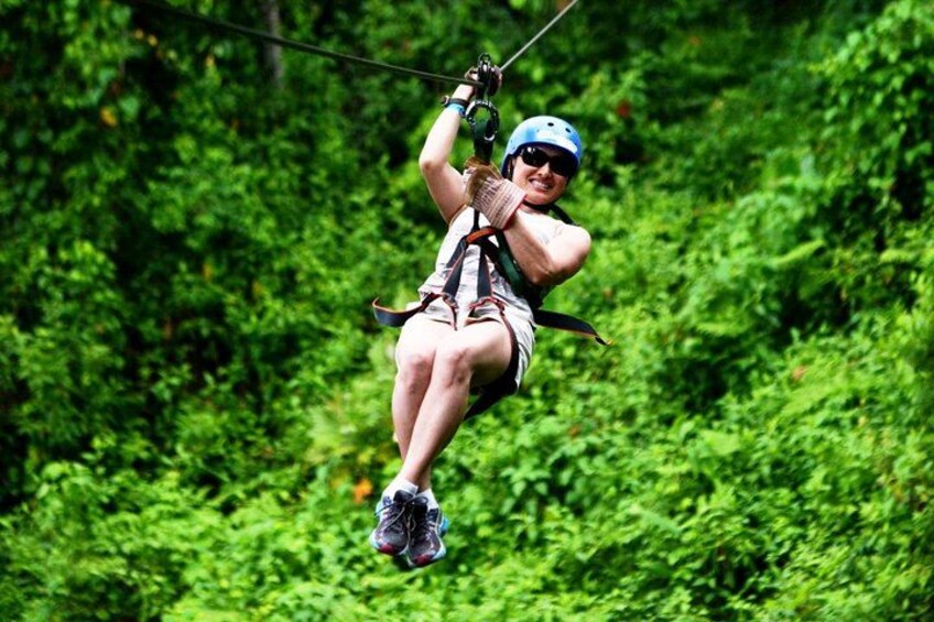 A person zip-lining through a forest. 2