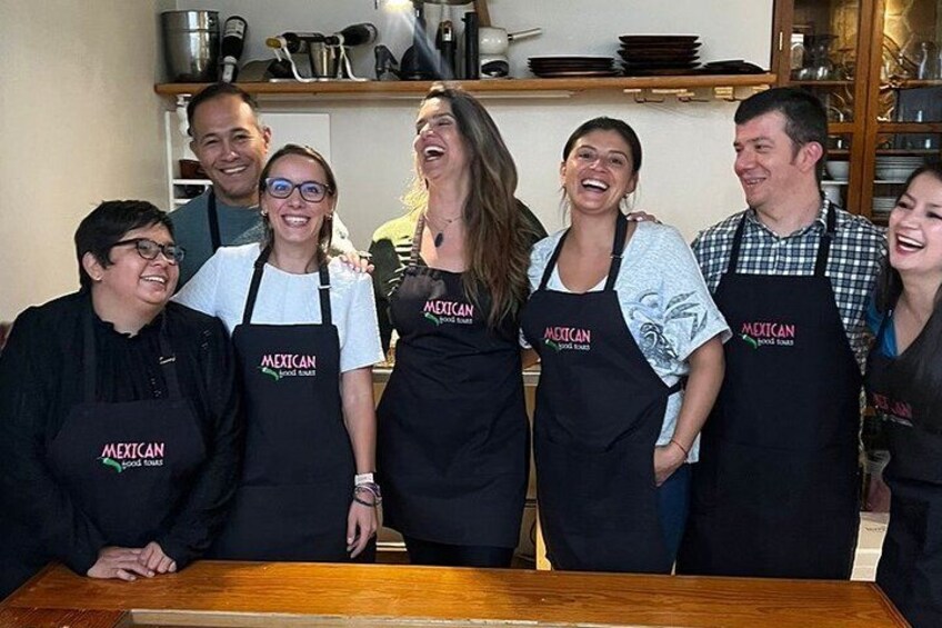 A group of people wearing aprons with 'Mexican food truck' printed on them. 5