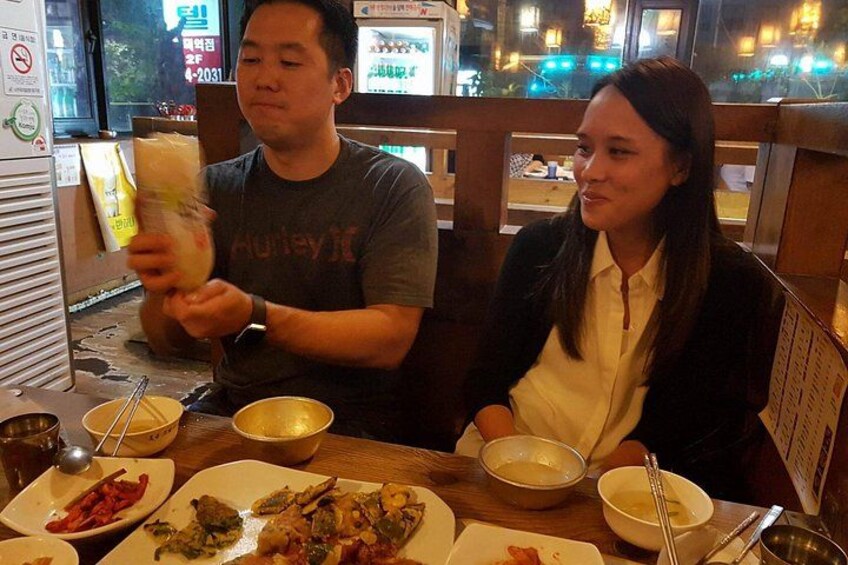 A man and a woman dining at a restaurant with various dishes on the table. 5