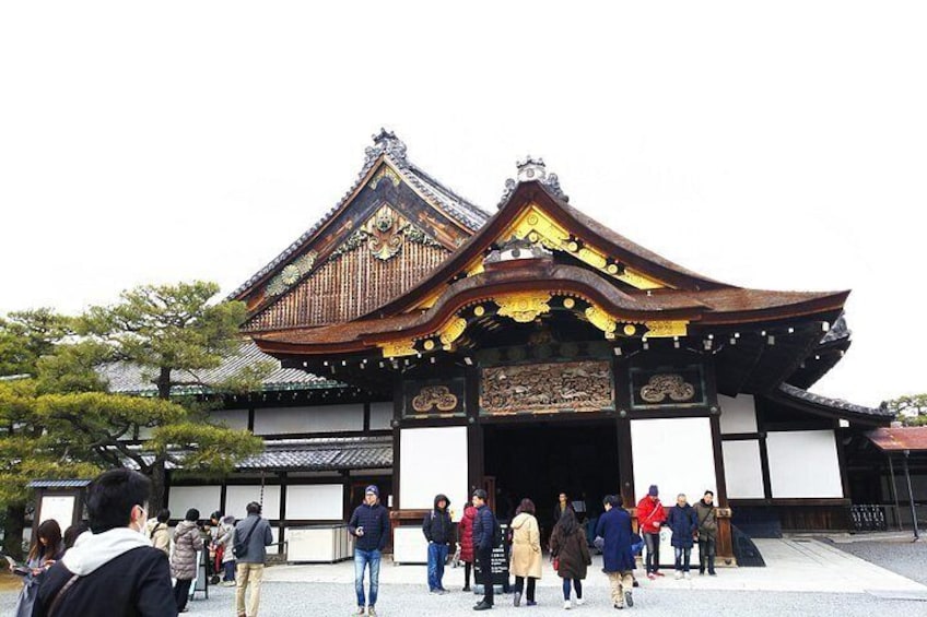 A traditional Japanese building with a curved roof and ornate decorations. 5