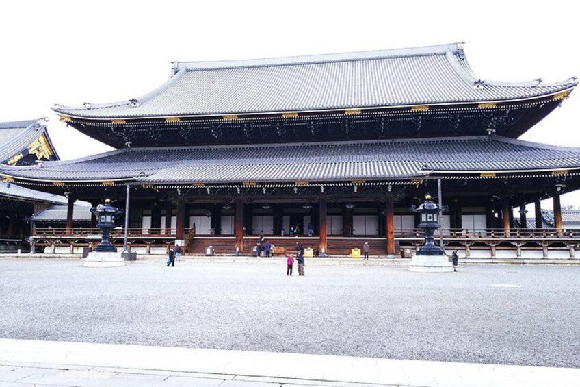 A traditional Japanese building with a tiled roof and wooden beams. 4