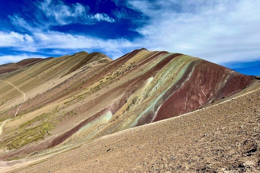 A rugged mountain landscape with distinct color bands. 3
