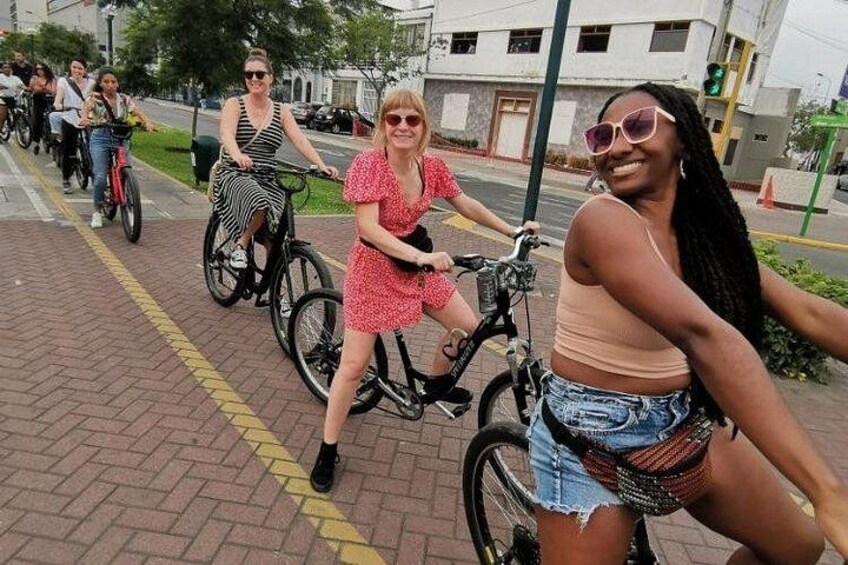 People riding bicycles on a paved path. 2