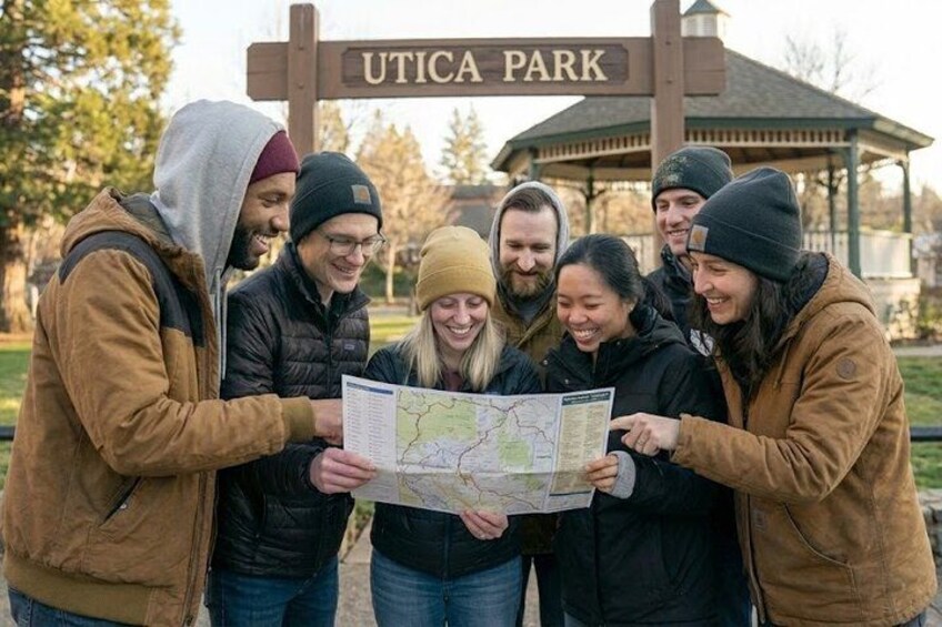 A group of people at Utica Park holding a map. 1