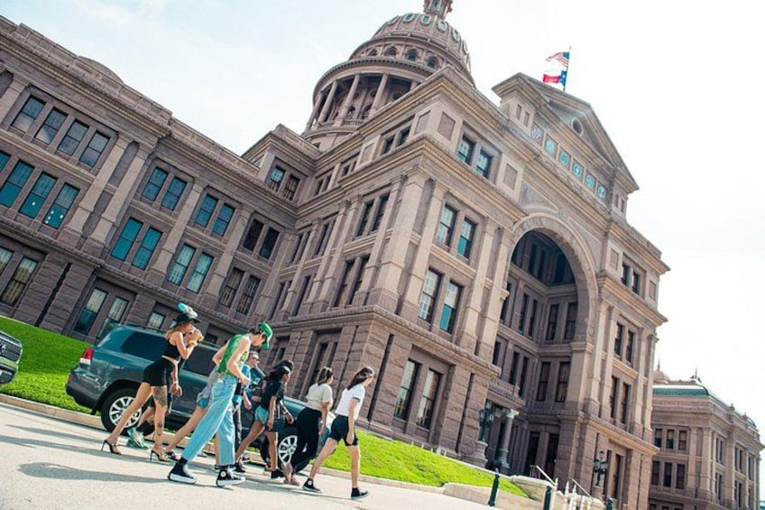 A large, historic building with a dome and flag. 4
