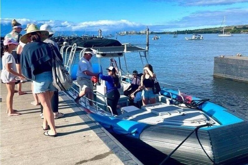A boat docked at a pier with people boarding and disembarking. 2