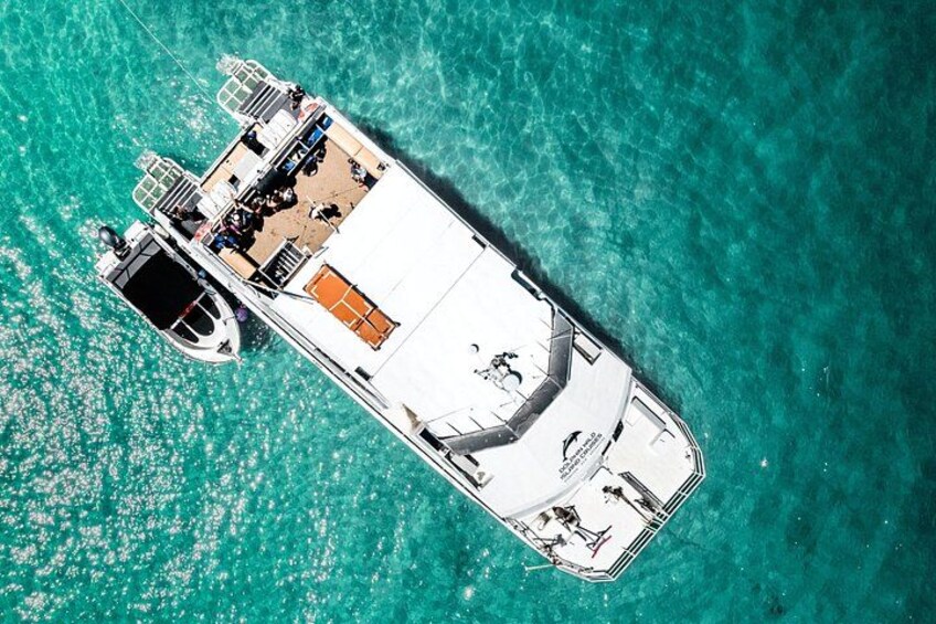 A large yacht docked in turquoise waters. 2
