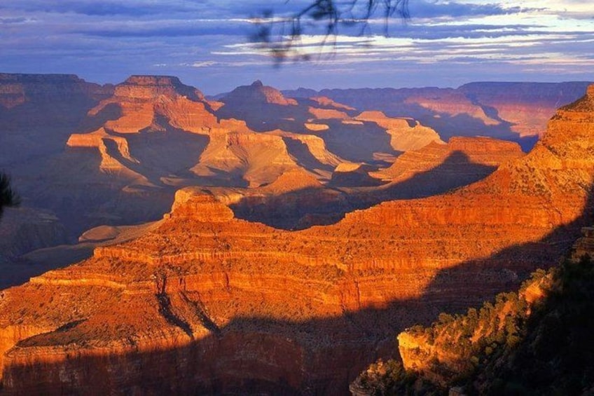 A canyon landscape with layered rock formations and a clear sky. 1