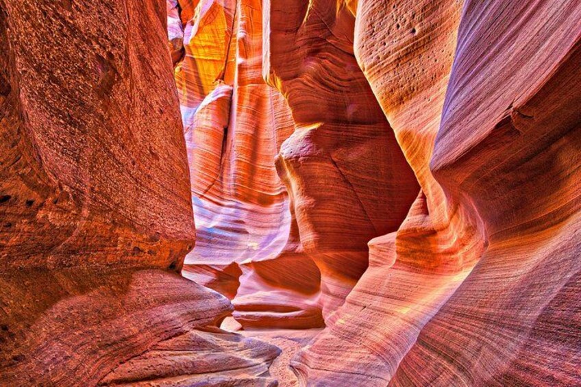 A canyon with red and orange rock formations. 1