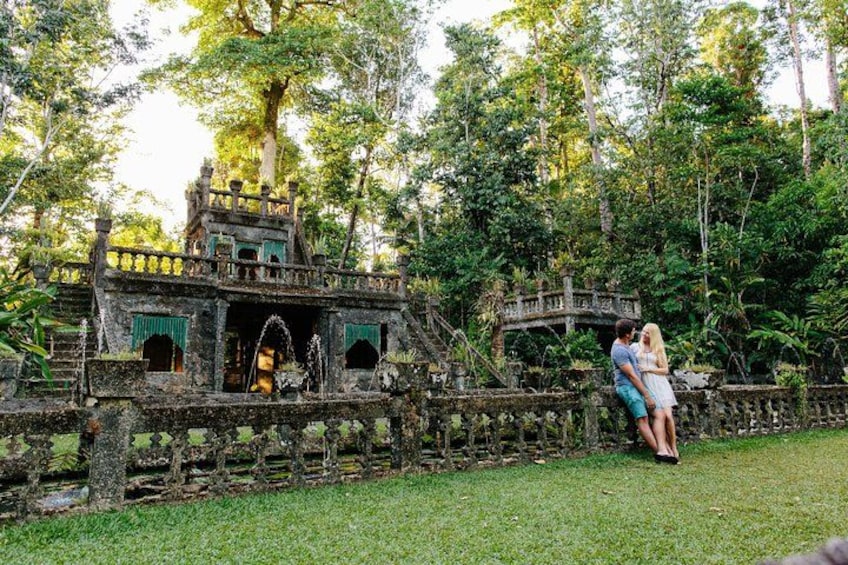 A stone bridge, a stone building, and lush greenery. 1