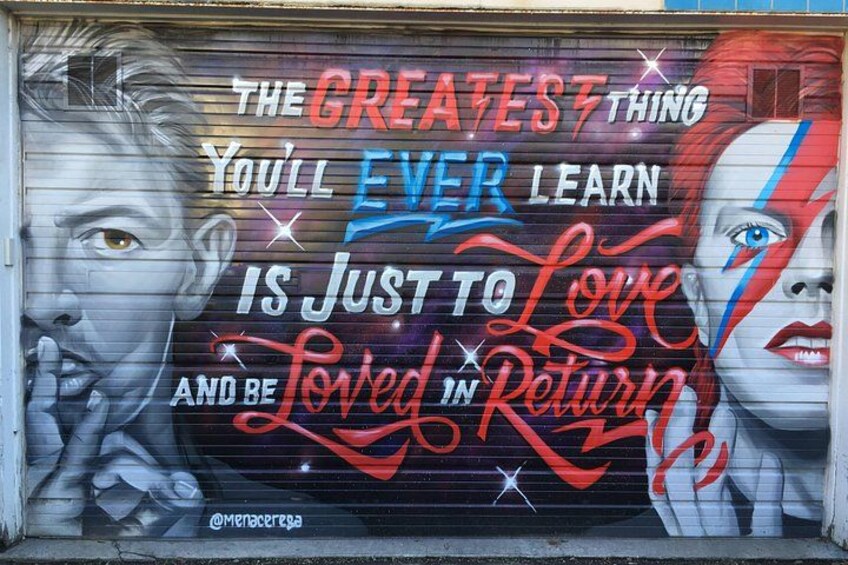 A mural with a quote about love and being loved in return. 3