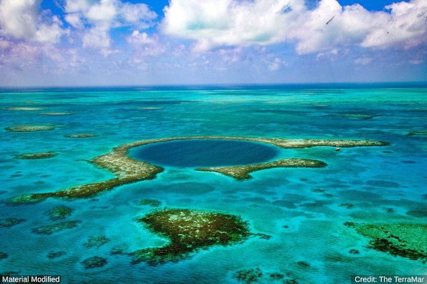 A clear blue sea with coral reefs and a central lagoon. 1