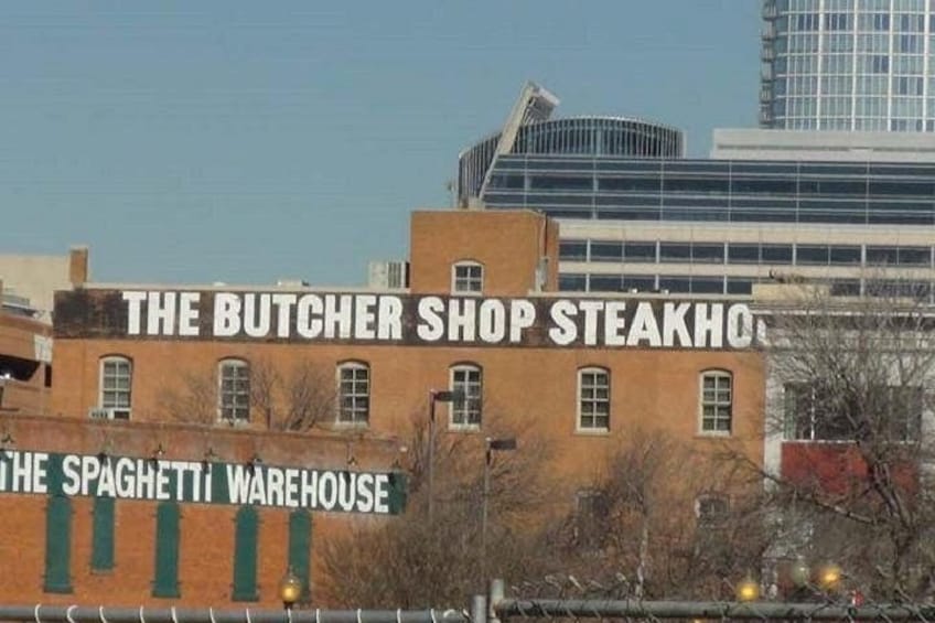 A building with signs reading 'The Butcher Shop Steakhouse' and 'The Spaghetti Warehouse.' 4
