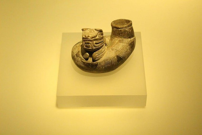 A sculpture on a white pedestal. 5