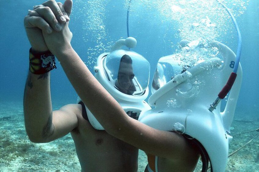 A person underwater with a scuba diving mask and regulator. 3