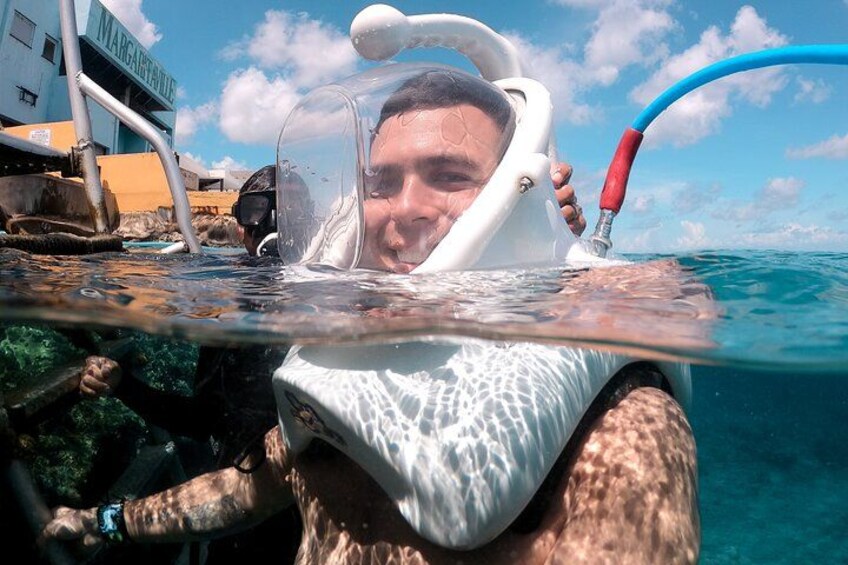 A person snorkeling with a mask and snorkel, underwater near a boat. 4