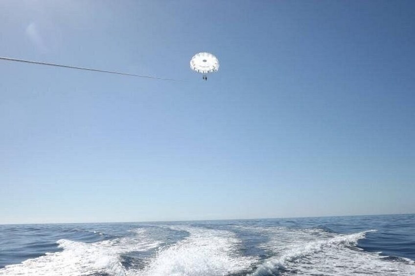 A clear sky, calm sea, and a distant buoy. 2